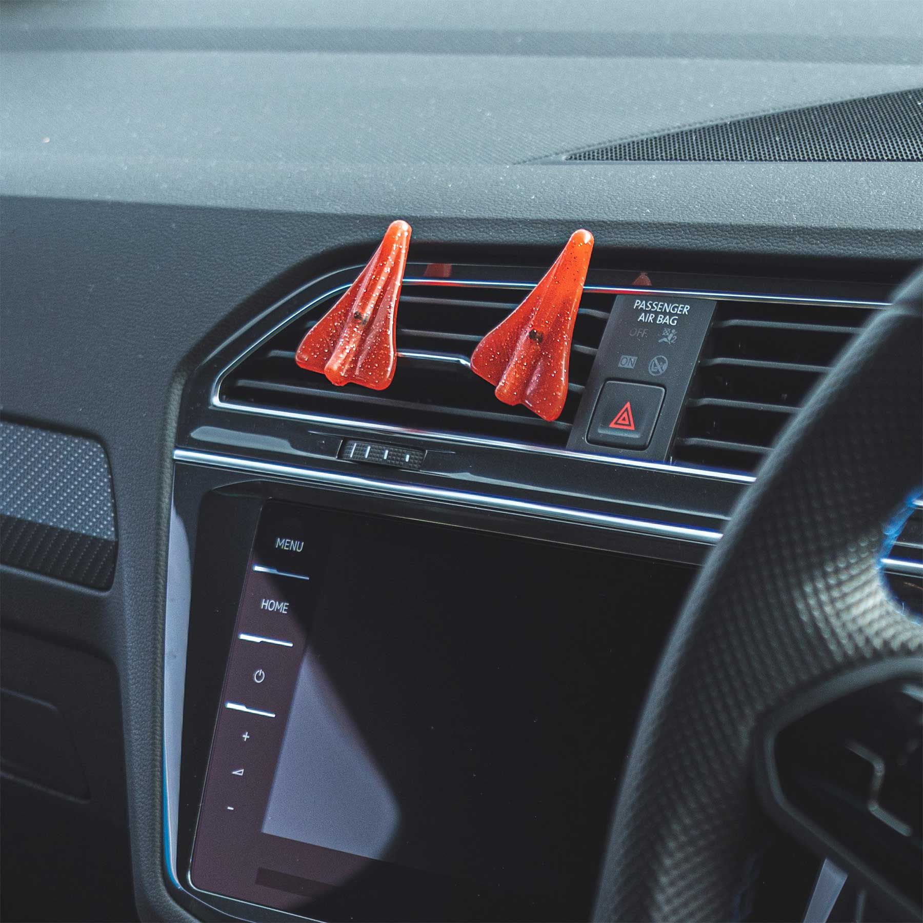 Pair of Jelly Jets Sparkle Air Fresheners clipped to car air vent.