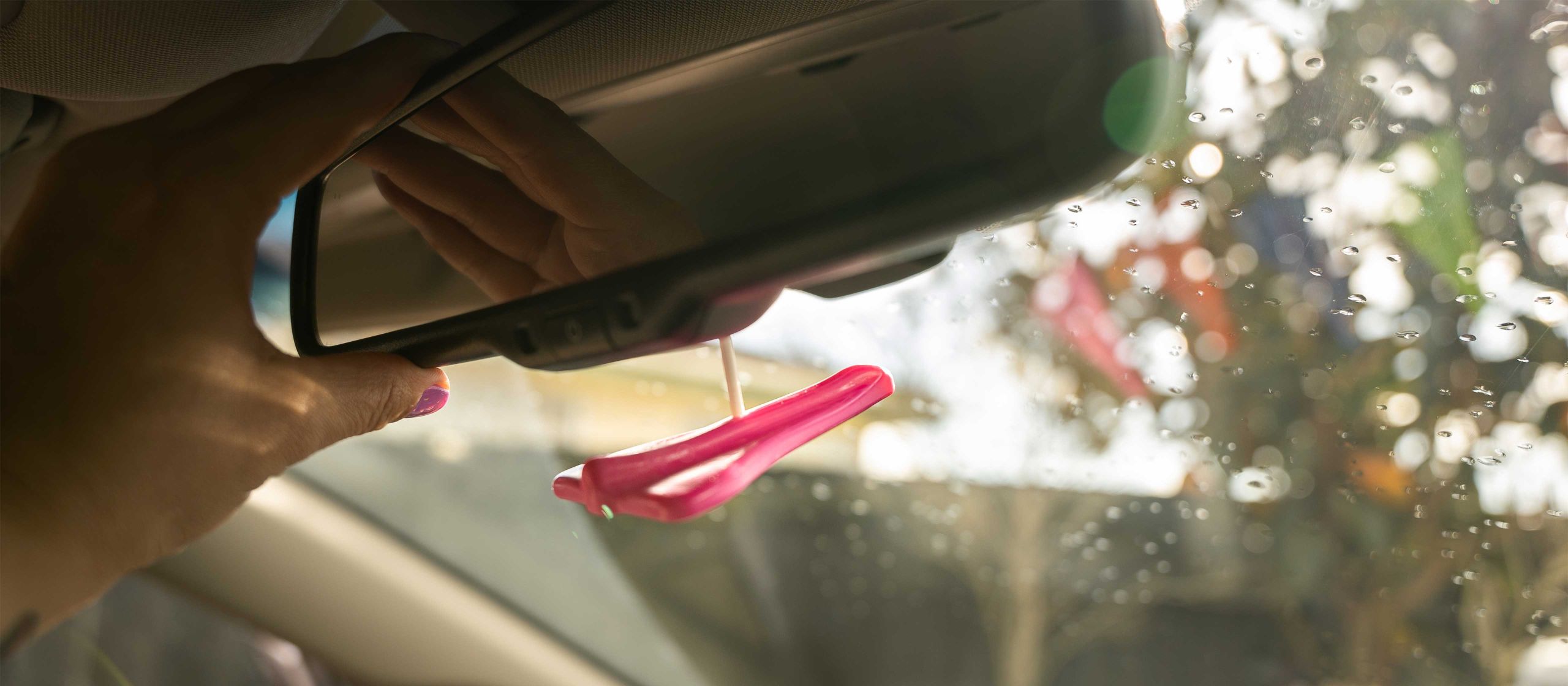 Jelly Jets Air Freshener hanging from car rear view mirror